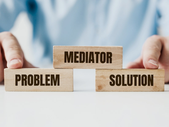 Wooden blocks reading Problem, Mediator, and Solution — representing AXIS's structured approach to dispute resolution